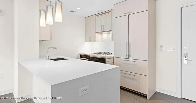a stove top oven sitting inside of a kitchen