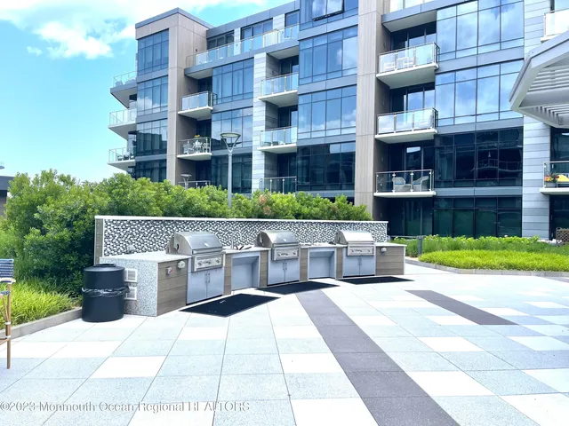 a patio with glass top table and chairs
