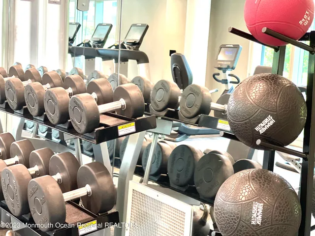 a living room with stainless steel appliances kitchen island granite countertop furniture and a large window