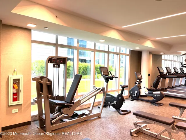 a living room with furniture and view of kitchen