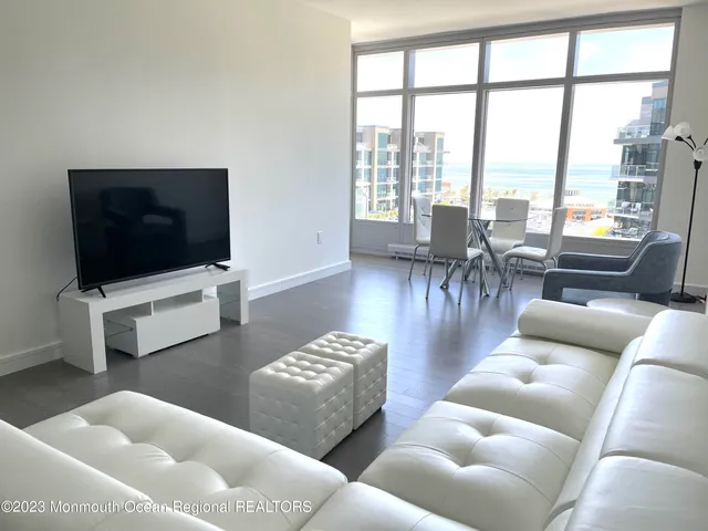 a bedroom with a bed couch and a large window