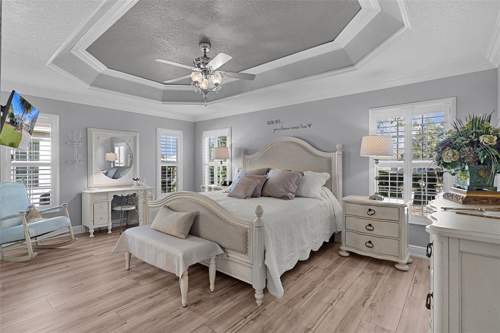 2211 Bachman Path The Villages, FL 32162 - Photo 23 of 60 a bedroom with a bed and a chandelier