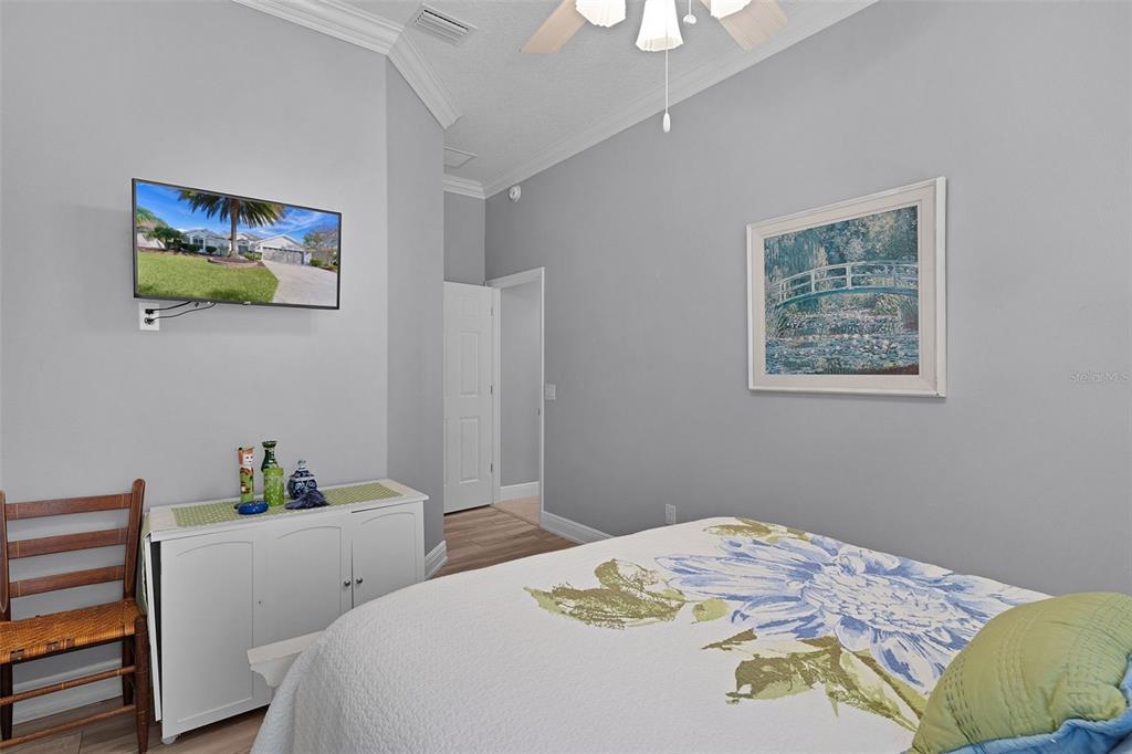 2211 Bachman Path The Villages, FL 32162 - Photo 36 of 60 a bedroom with a bed and a lamp on dresser