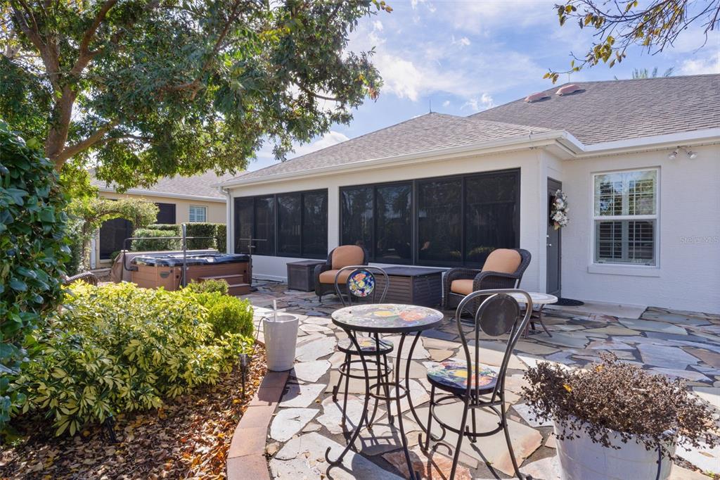 2211 Bachman Path The Villages, FL 32162 - Photo 44 of 60 a view of a patio with table and chairs potted plants and large tree