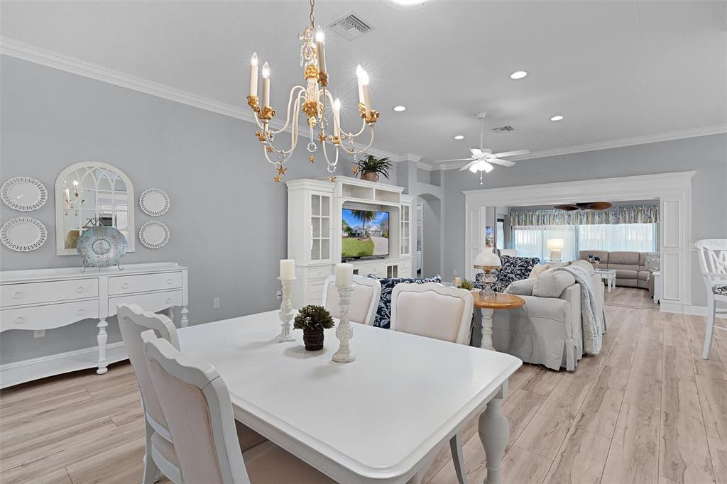 2211 Bachman Path The Villages, FL 32162 - Photo 9 of 60 a view of a dining room with furniture and wooden floor