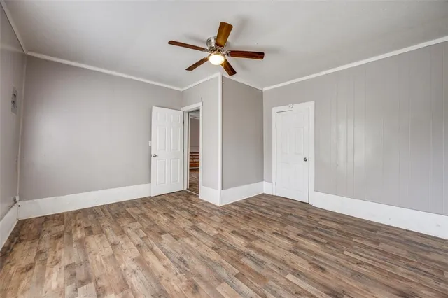 a view of a room with window and a ceiling fan