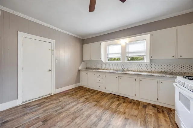 a view of hallway with wooden floor