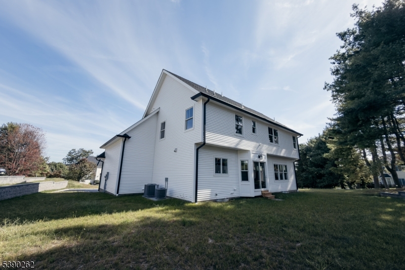 4 Hemlock Circle Warren, NJ 07059 - Photo 28 of 28 a view of a white house next to a yard with big trees