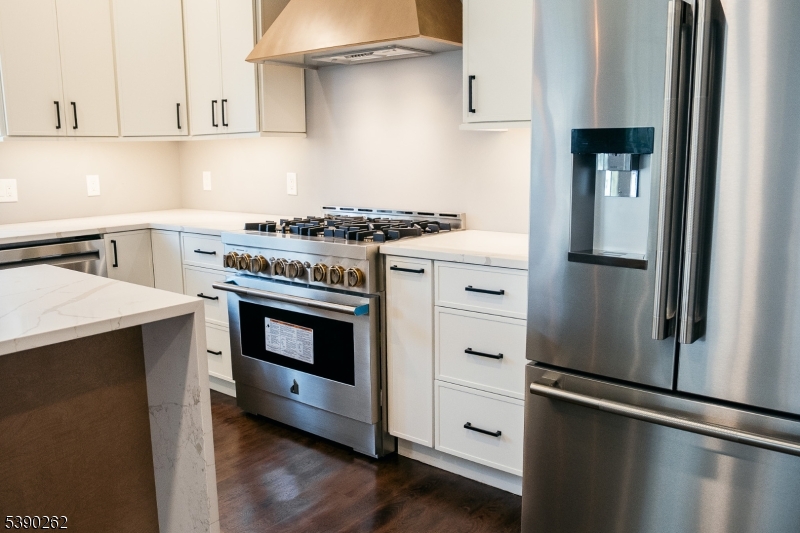 4 Hemlock Circle Warren, NJ 07059 - Photo 6 of 28 a kitchen with stainless steel appliances a stove and a refrigerator