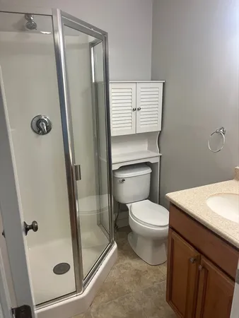 a bathroom with a toilet and a shower