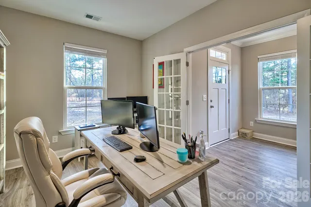 a view of a dining room with furniture wooden floor and chandelier