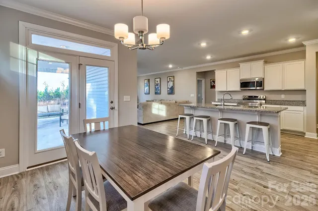 a kitchen with stainless steel appliances granite countertop a sink stove refrigerator and cabinets
