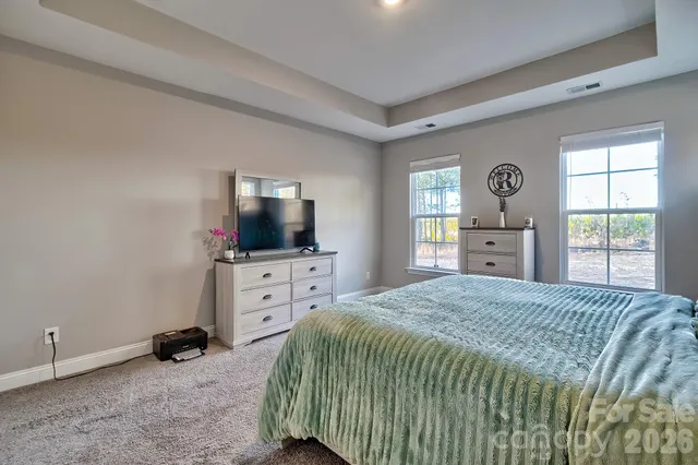 a bathroom with a granite countertop double vanity sink and a mirror