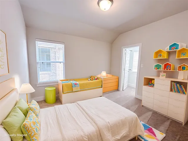 a bedroom with a bed and a couch