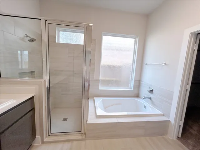 a bathroom with a bath tub and shower