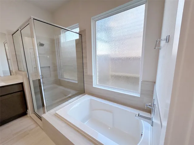 a bathroom with a tub and a shower