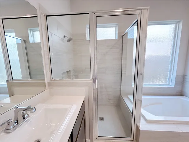 a bathroom with a tub and a shower