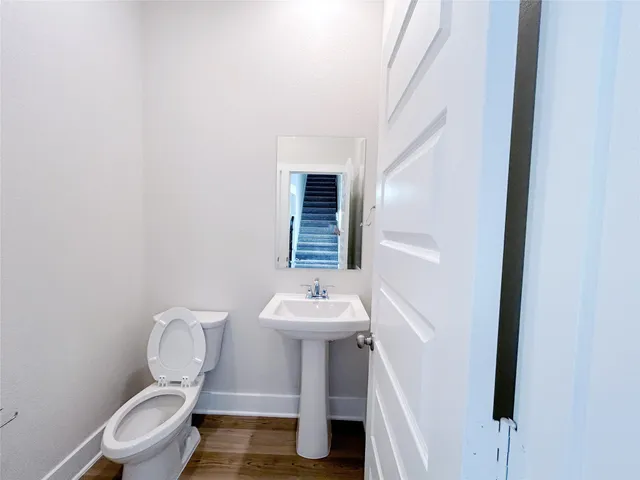 a bathroom with a double vanity sink toilet mirror and shower