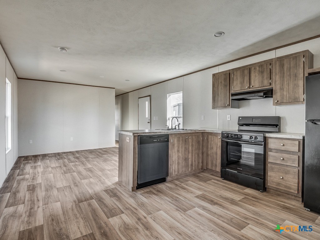 352 Trammel Road Eddy, TX 76524 - Photo 6 of 11 a kitchen with stainless steel appliances granite countertop a stove a sink and a refrigerator