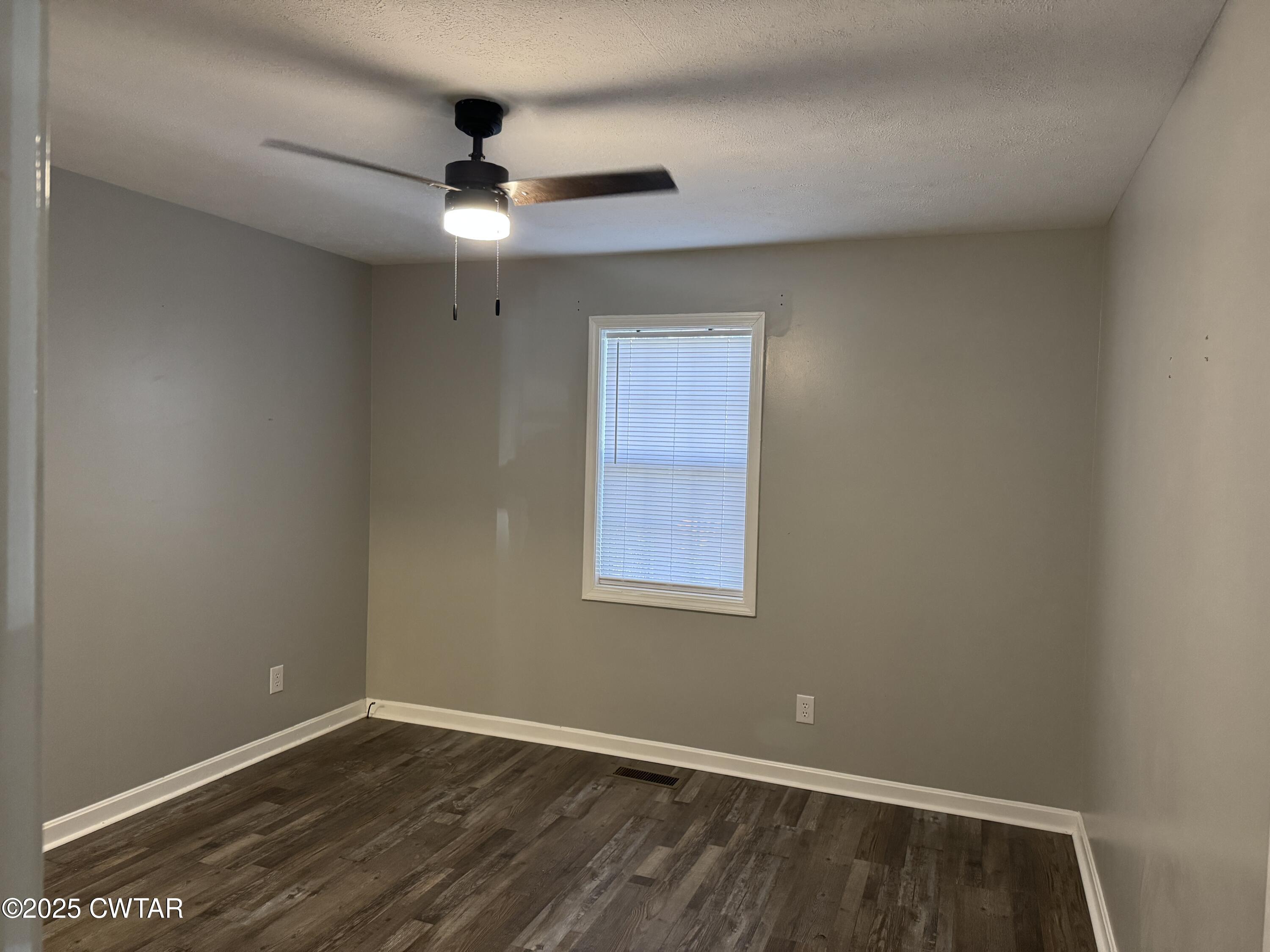 380 Patterson Lane Finger, TN 38334 - Photo 11 of 25 a view of an empty room with wooden floor and a window