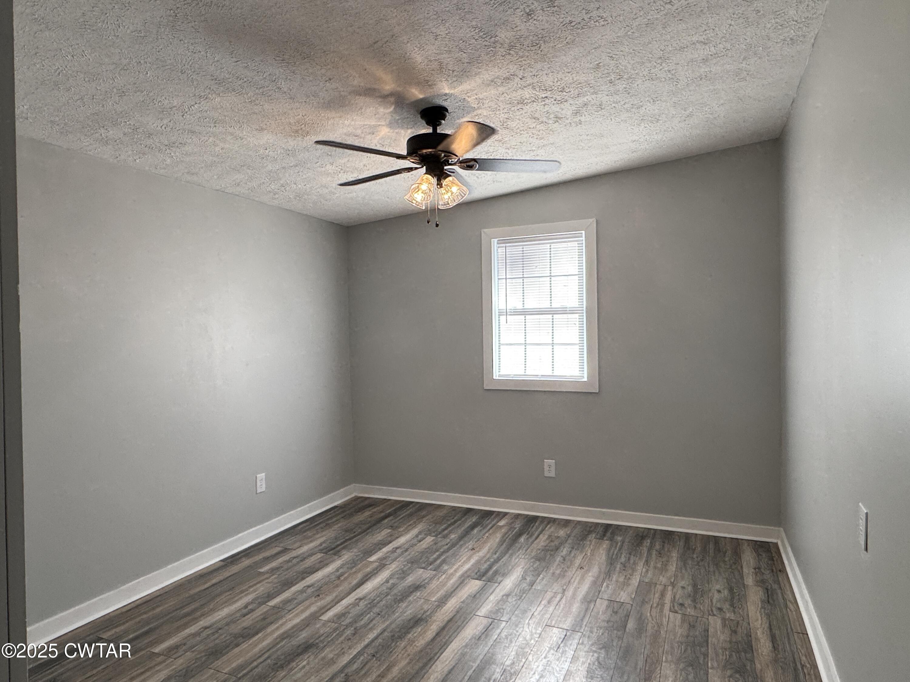 380 Patterson Lane Finger, TN 38334 - Photo 14 of 25 an empty room with a window and a ceiling fan