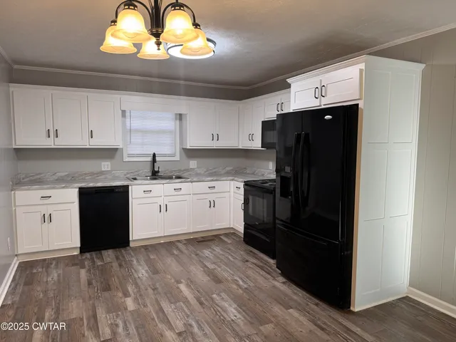 a kitchen with a stove a refrigerator and a sink