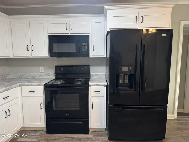 a kitchen with granite countertop a refrigerator and a stove