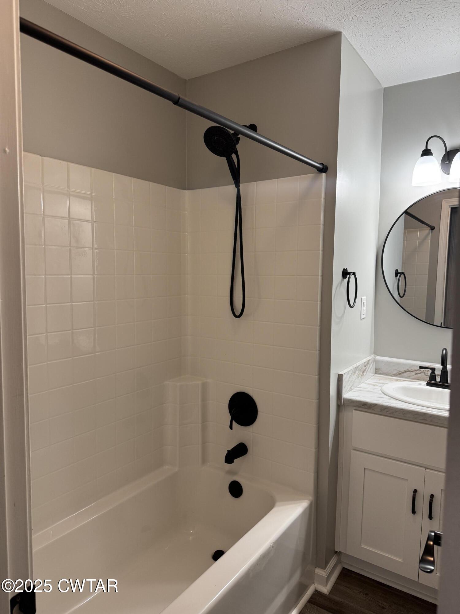 380 Patterson Lane Finger, TN 38334 - Photo 20 of 25 a bathroom with a bath tub a sink and a mirror