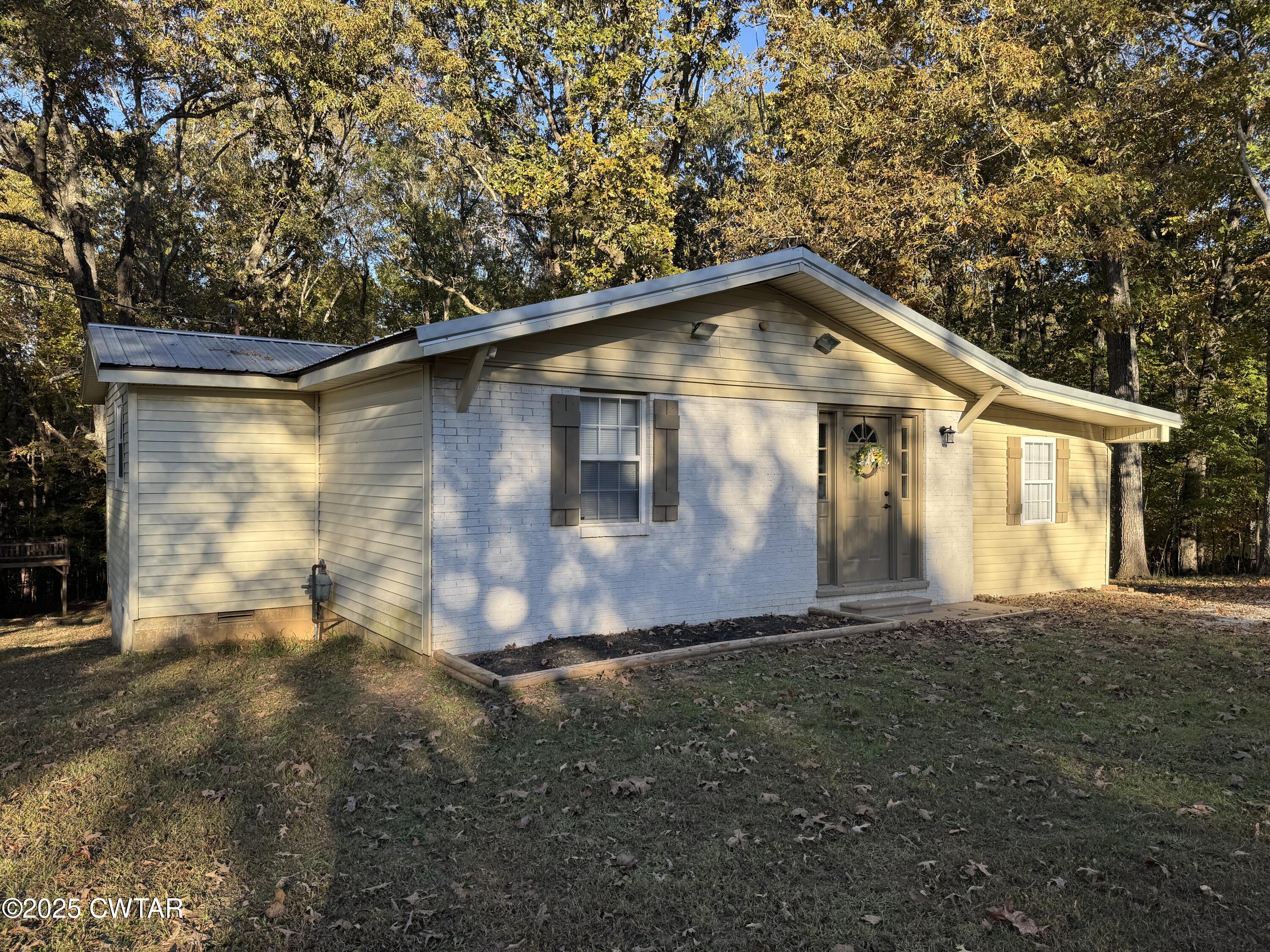 380 Patterson Lane Finger, TN 38334 - Photo 2 of 25 a front view of a house with a yard