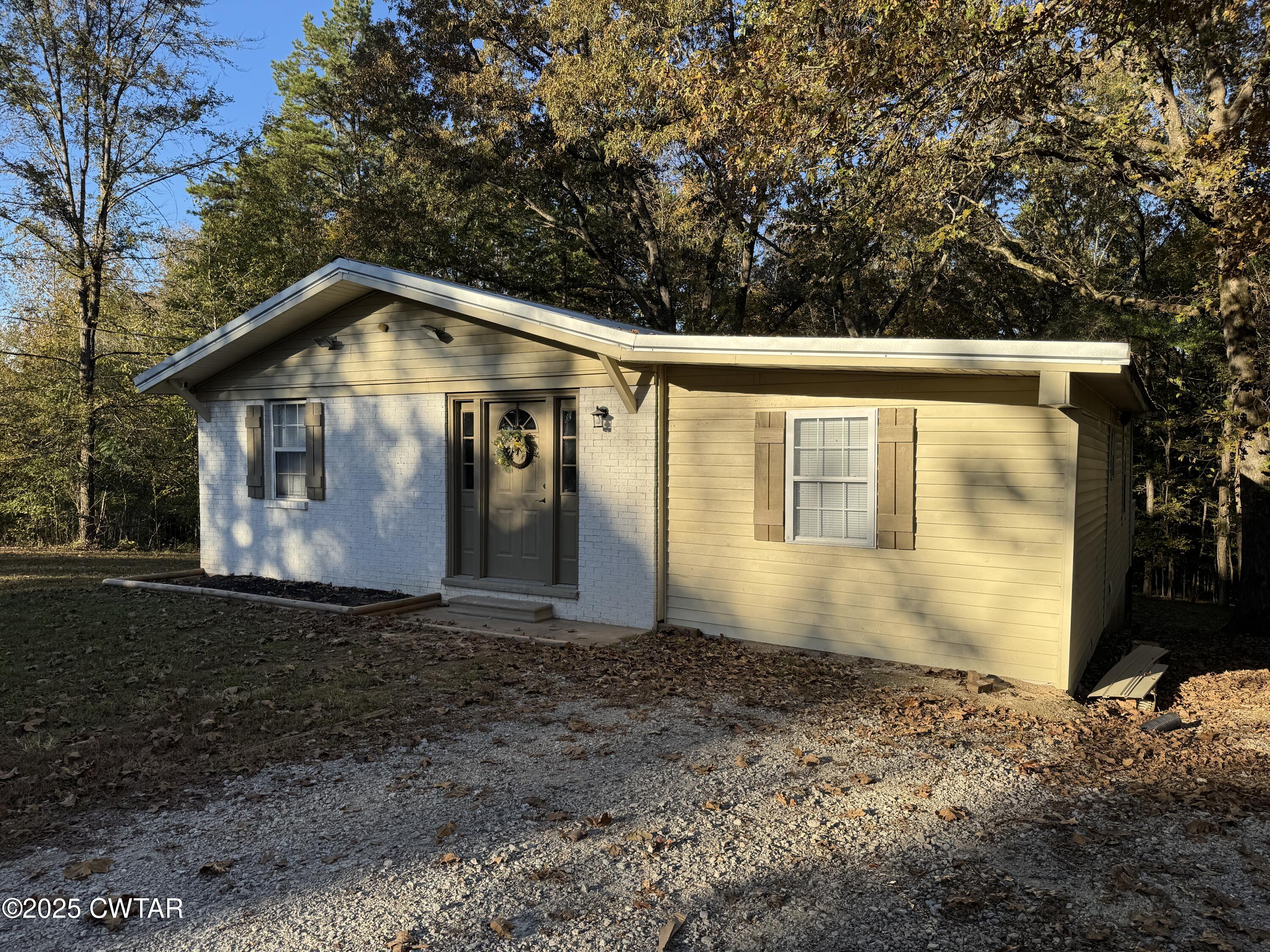 380 Patterson Lane Finger, TN 38334 - Photo 3 of 25 a front view of a house with garden