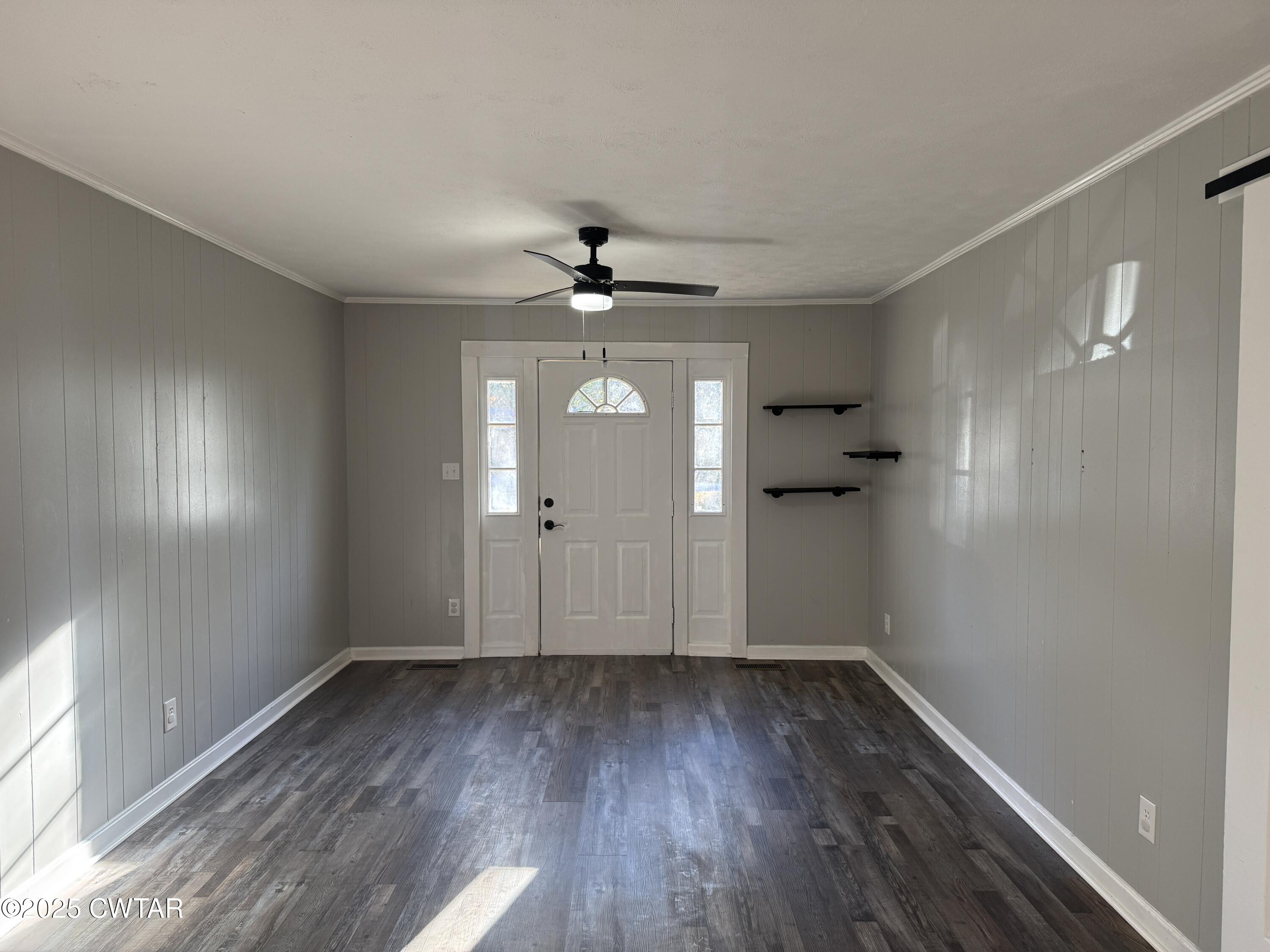 380 Patterson Lane Finger, TN 38334 - Photo 8 of 25 a view of an empty room with wooden floor and a window