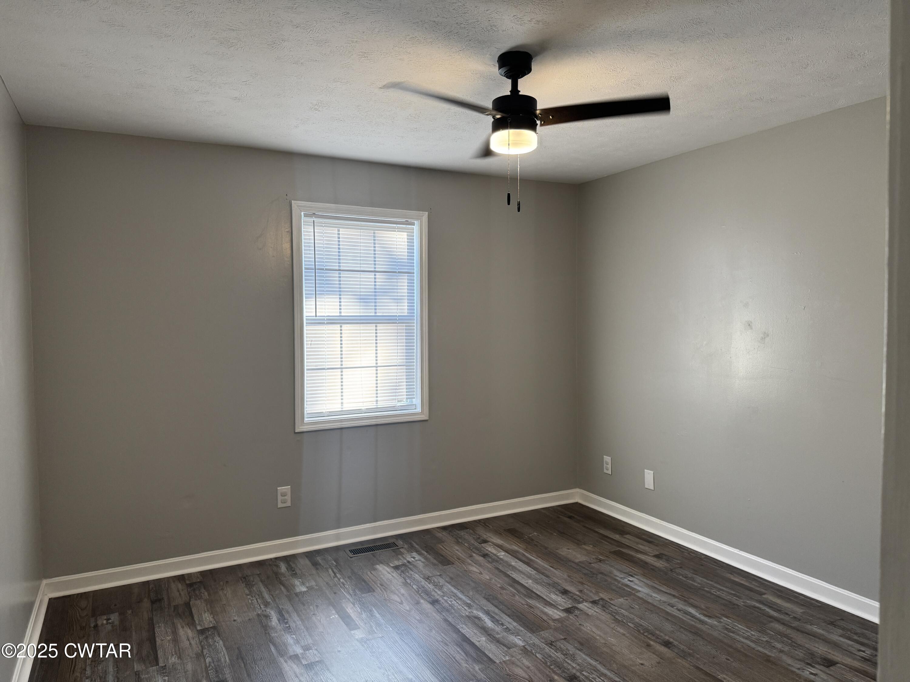 380 Patterson Lane Finger, TN 38334 - Photo 10 of 25 an empty room with a window and a fan