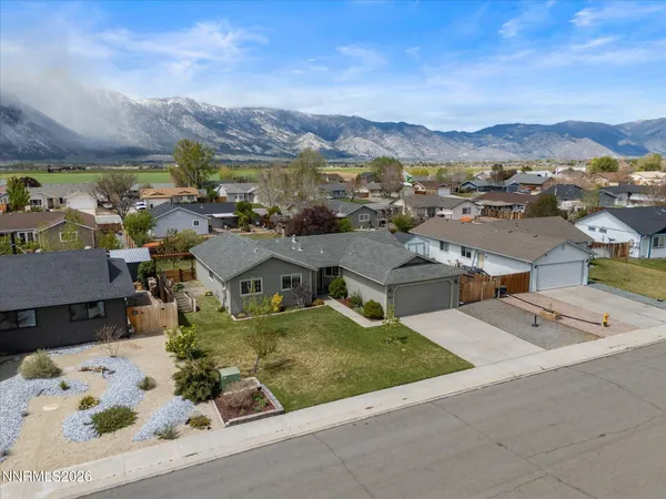 an aerial view of residential houses with outdoor space and street view