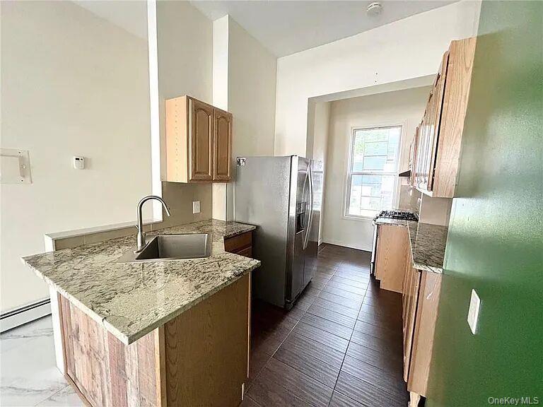 296 Mill Street Poughkeepsie, NY 12601 - Photo 4 of 19 a kitchen with stainless steel appliances granite countertop sink refrigerator and stove