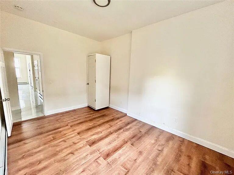 296 Mill Street Poughkeepsie, NY 12601 - Photo 6 of 19 a view of a room with wooden floor and a window