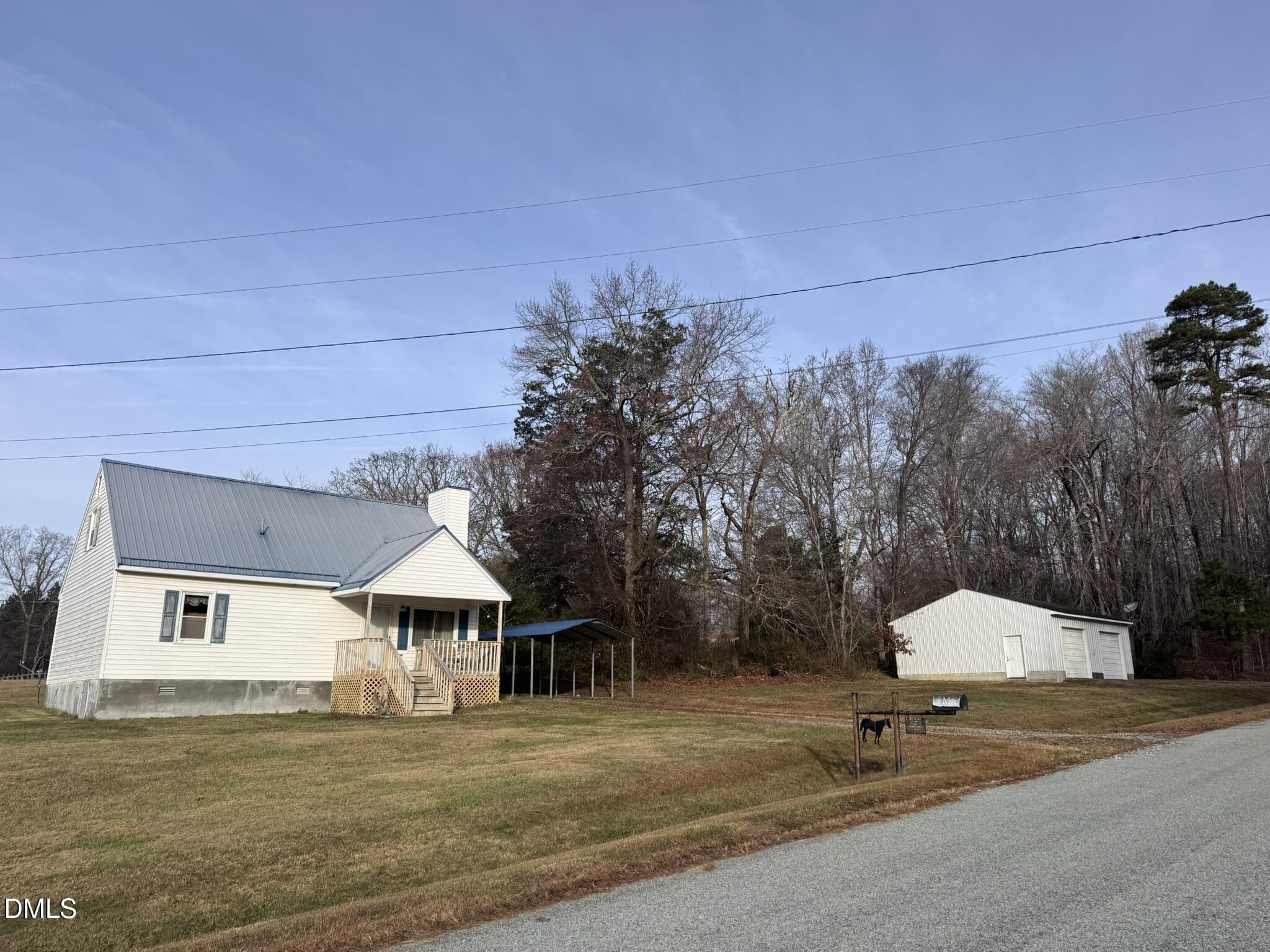 a front view of a house with a garden and trees
