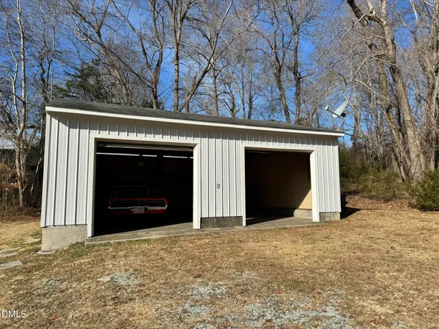 a view of a house with a yard and garage