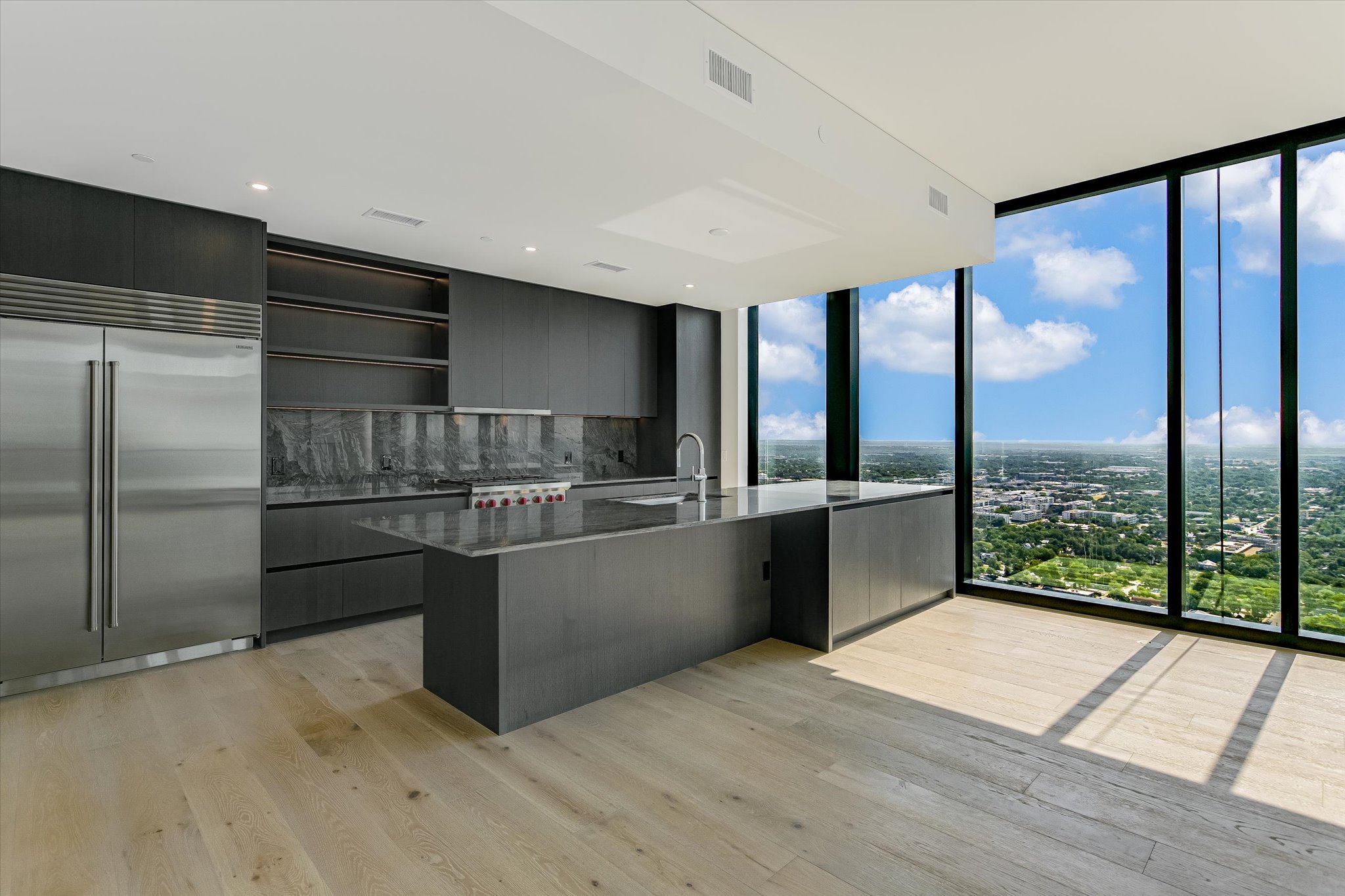 610 Davis Street, Unit 3801 Austin, TX 78701 - Photo 4 of 40 a kitchen with stainless steel appliances granite countertop a refrigerator and a sink