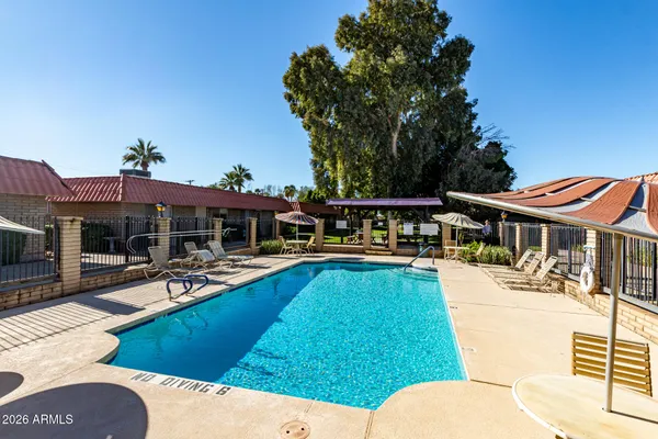 a view of a house with swimming pool and sitting area