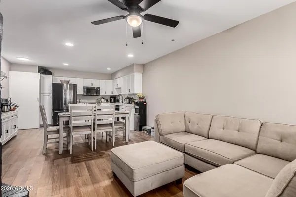 a living room with furniture and kitchen view
