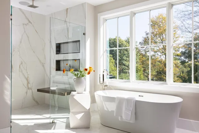 a living room with large windows and a table