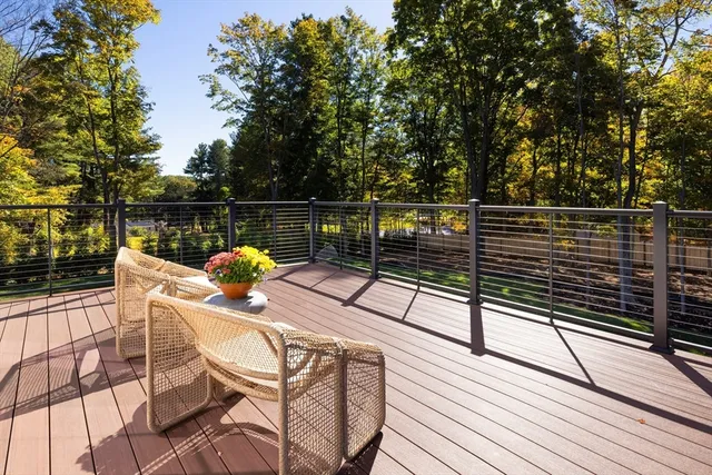 a view of a balcony with chairs and wooden floor