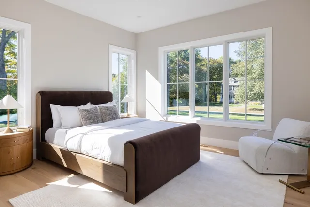 a bedroom with a bed and glass window
