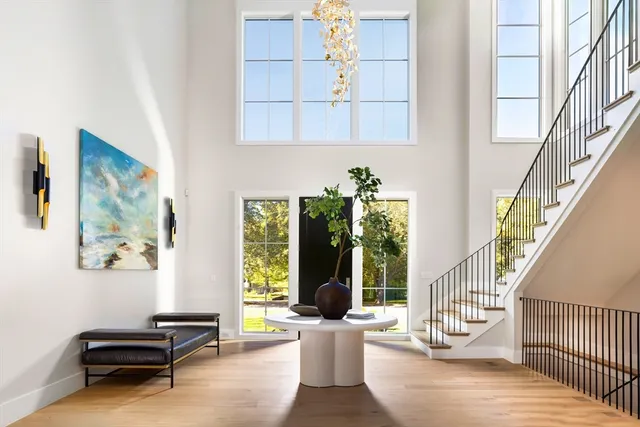 a living room with furniture and large windows