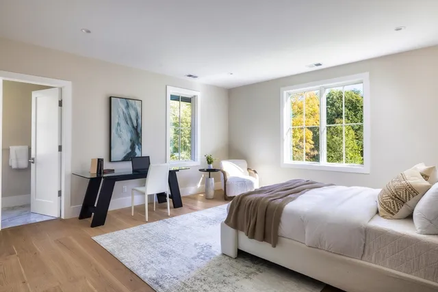 a bedroom with a bed and a large window