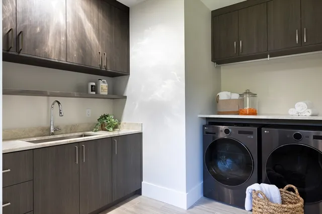a utility room with wooden floor and cabinets