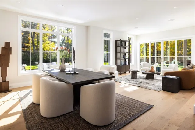 a living room with furniture and large windows