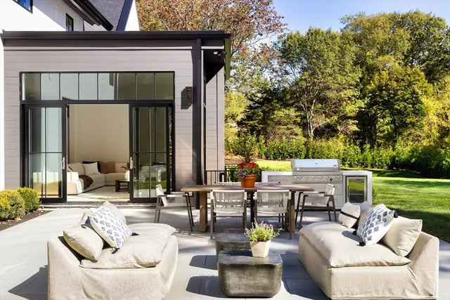 a view of backyard of house with seating space