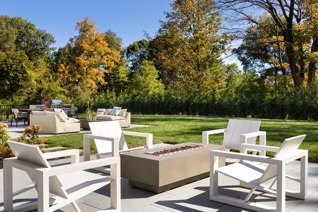 a view of a patio with a table chairs and a yard