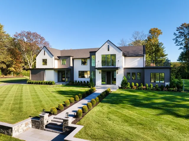 a view of a house with a yard patio and swimming pool